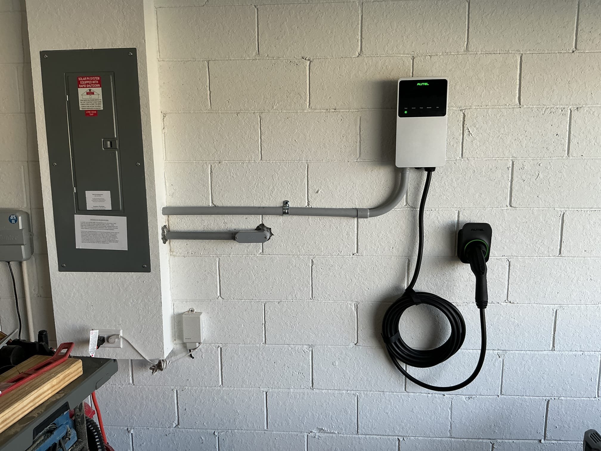 Completed EV charger installation on a garage wall